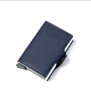 Detail view of the pop-up mechanism on the blue leather aluminum wallet case
