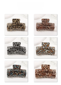Detail view of acetate claw hair clips in six distinct leopard and tortoiseshell patterns