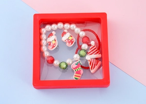 Christmas jewelry gift set for kids with Santa and snowflake motifs in a red display box