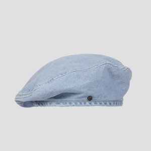 Detail view of light blue denim beret fabric with vintage metal buckle and stitching