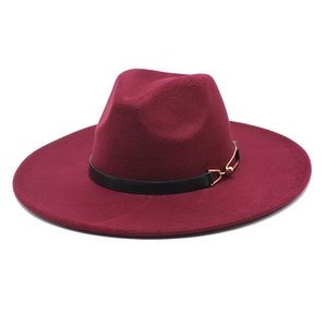 Detail of burgundy wool fedora hat featuring black leather band and gold metal bead accents