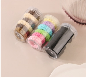 Three jars of colorful jacquard hair ties in plush and knitted textures for high ponytails
