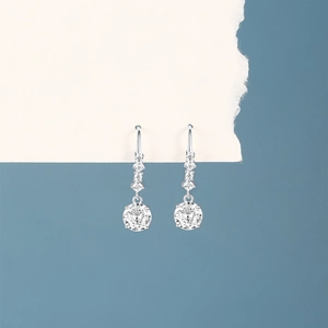 Detail of silver drop earrings with round clear zircon and micro-set small diamonds