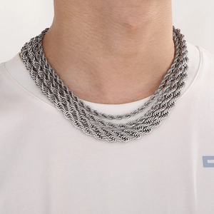 Close-up of tiered silver titanium steel twist rope chains worn on a model neckline