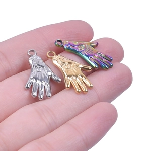 Detailed view of Hamsa Hand pendants in silver, gold, and iridescent finishes with evil eye