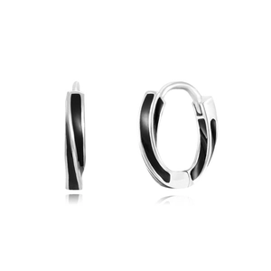 Detailed close-up of silver-tone spiral earrings with black enamel inlay and mirror reflection