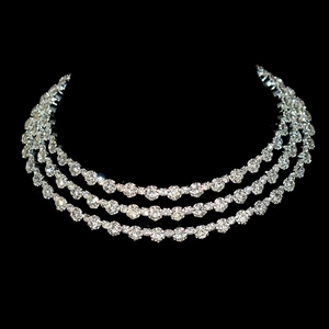 Elegant three-layer silver crystal necklace with sparkling round gemstones on black background