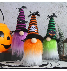 Three colorful Halloween gnomes with wizard hats and festive props against a stone wall