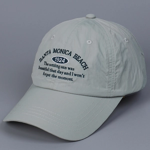 Detail of light grey quick-dry baseball cap with letter embroidery and curved brim