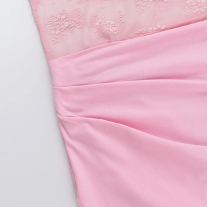 Detail of pink lace stitching and elegant pleated fabric texture on a summer dress