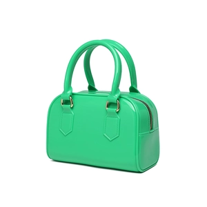 Detailed view of glossy green jelly handbag featuring a metallic zipper and twin handles