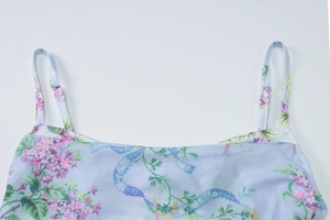 Detail of light purple floral dress showing the neckline and thin shoulder straps