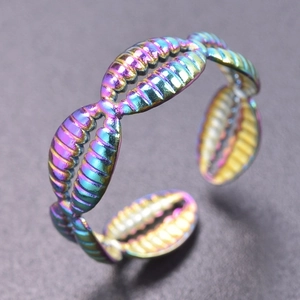 Macro shot of iridescent shell textured stainless steel open ring with colorful finish