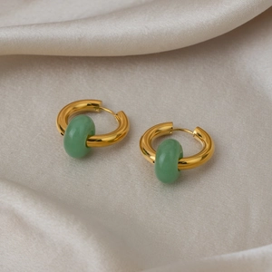 Detail of 18K gold stainless steel hoop earrings with green natural stone charms