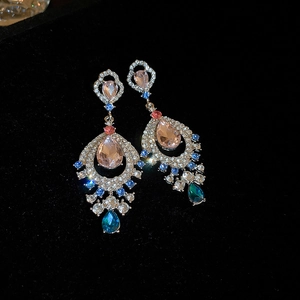 French vintage fan-shaped drop earrings with pink and blue crystals on black velvet
