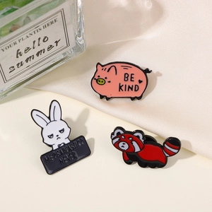 Detailed view of enamel badges featuring a pink pig, white rabbit, and cute red panda