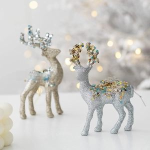 Detail showing two reindeer figurines with gold and silver glitter and colorful sequins