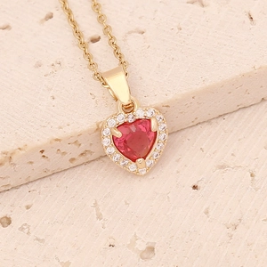 Detail of copper necklace with red heart zircon pendant surrounded by clear crystals
