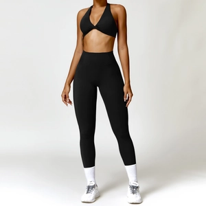 Two-piece black yoga set with twist front halter bra and high-waisted leggings