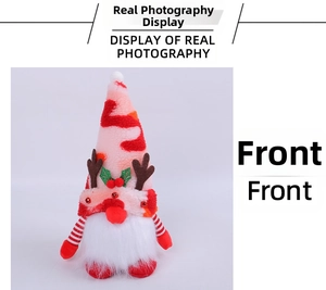 Close-up of Christmas gnome plush with reindeer antlers, bells, and holiday details