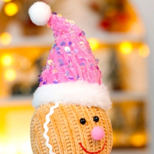 Charming orange gingerbread man plush with pink sequin hat and soft knit texture