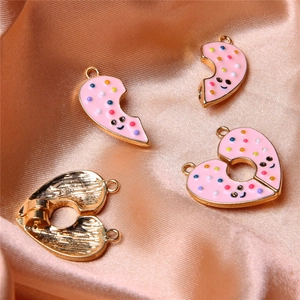 Macro view of pink donut heart pendant with magnetic pairing and golden plating