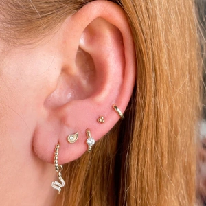 Close-up of S925 silver gold-plated ear stack with zircon heart and hoop earrings