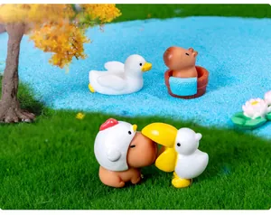 Detailed view of Capybara and duck resin figurines in a lush miniature garden setting