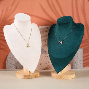 Detail of velvet bust necklace stands with solid wood bases on decorative marble