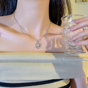 Elegant silver crescent moon and star pendant necklace with zircons on model neck
