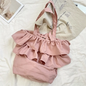 Detailed view of pink tiered ruffle tote bag with secure metal button closure