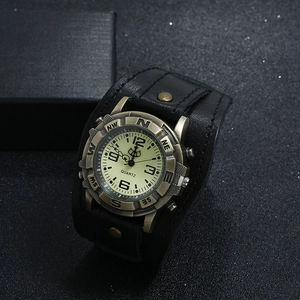 Detail of vintage black leather punk watch with bronze case and rivet strap details