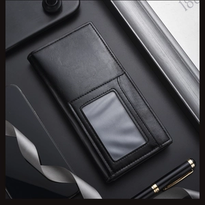 Detail of black leather long wallet featuring a clear ID window and fine lychee texture