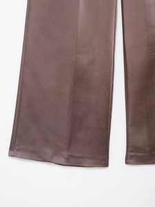 Detailed close-up of dark brown satin wide-leg pants showing premium fabric texture