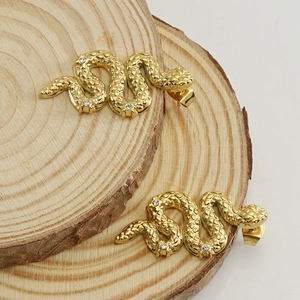 18K gold plated stainless steel snake stud earrings with zircon stones on wood