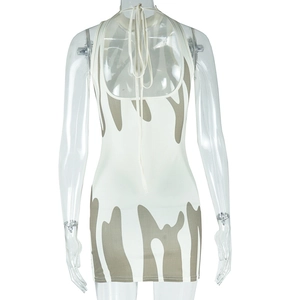 Detail view of backless halter dress with green marble print and lace-up design