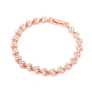 Rose gold heart bracelet with zircon stones shown from a top-down view on white background