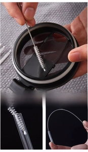 Flexible stainless steel straw cleaner brush showing detail of white bristles and protection tip