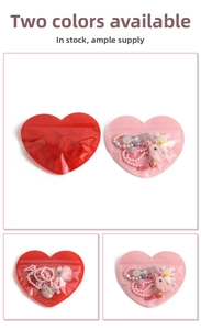 Macro detail of heart-shaped zip-lock bags containing colorful hair accessory sets