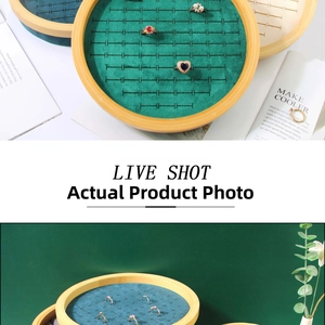 Macro detail of round bamboo jewelry tray with velvet ring slots and natural wood finish