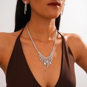 Detailed view of silver zircon tassel necklace and matching fringe earrings set