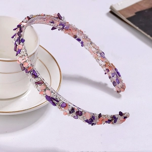 Detailed macro view of plastic hair comb with purple and orange crushed stones