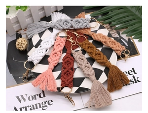 Detail of multi-colored macrame cotton tassel keychains with golden metal lobster clasps