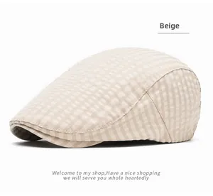 Close-up of beige checkerboard pattern fabric and curved brim on a retro flat cap