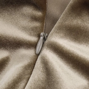 Macro shot of invisible zipper detail on premium khaki velvet pleated dress fabric