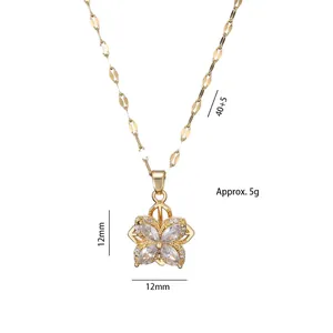Elegant rotating golden four-leaf clover necklace with sparkling cubic zirconia insets