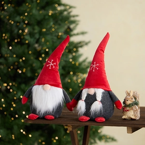 Christmas faceless gnome dolls with red hats and white beards on a wooden surface