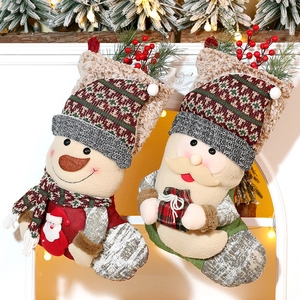 Detailed close-up of knitted Christmas stockings featuring Santa and Snowman designs