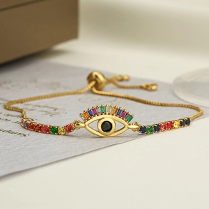 Adjustable evil eye bracelet with colorful zircons and gold chain on aesthetic background