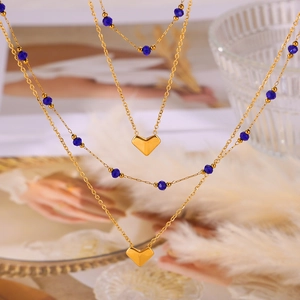 Double-layered gold titanium necklace with blue crystal beads and heart pendants